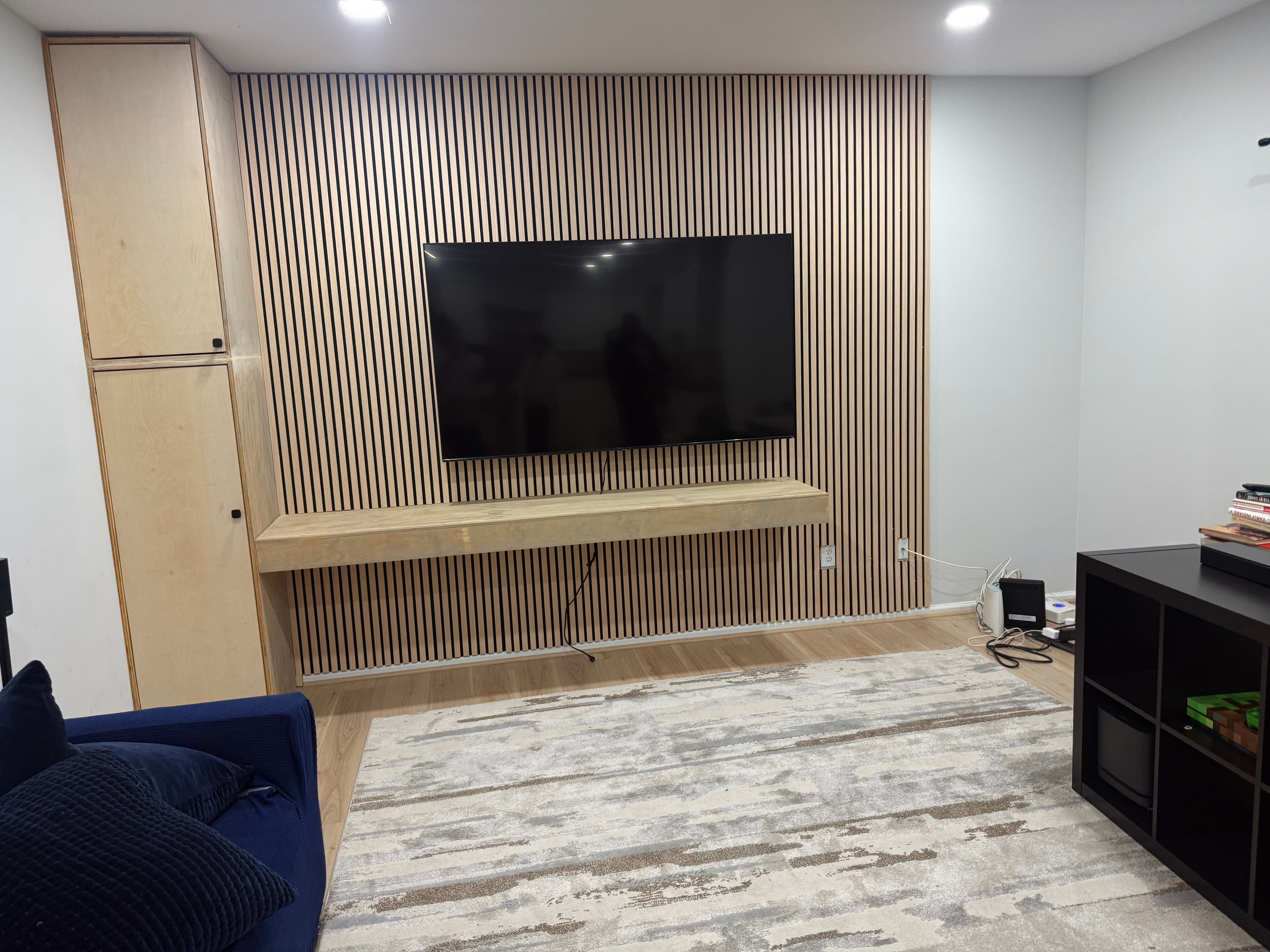 TV Accent Wall with Wooden Slats and Floating Shelf